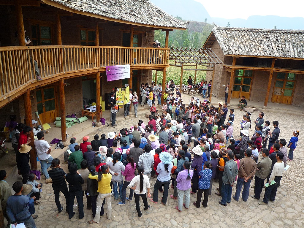Villagers gather around in the community center to attend the health inervention