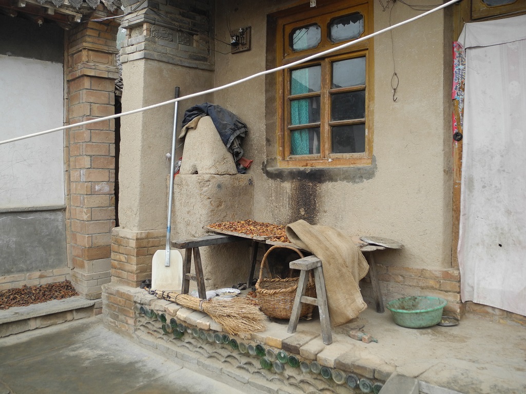 Villagers use beer bottles as solid support to the household structure