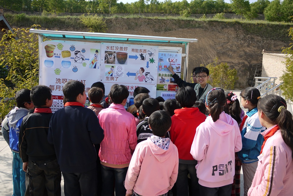 Volunteers doing poster presentation to promote water and health